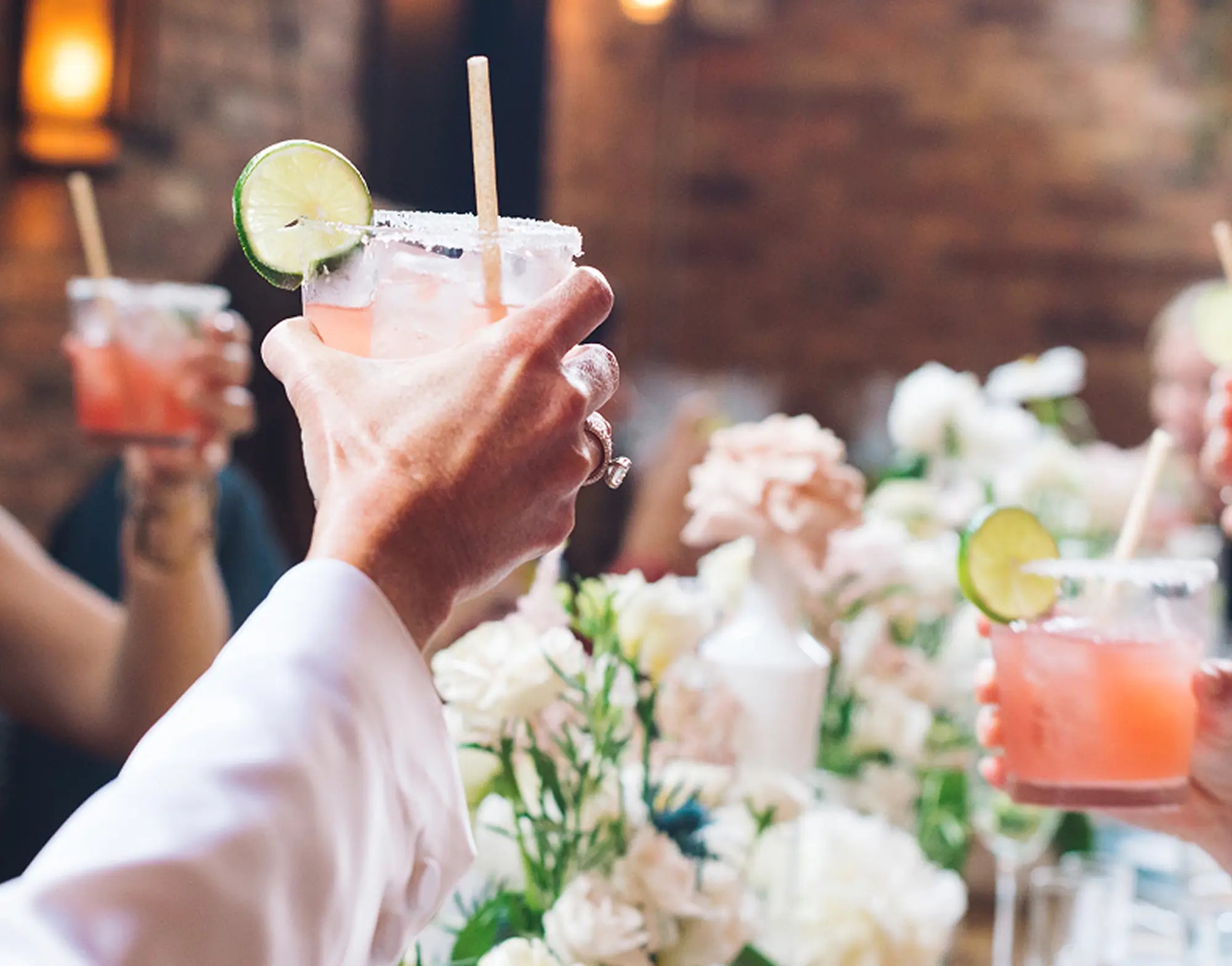 Glass raised with Inspiro Tequila cocktail.