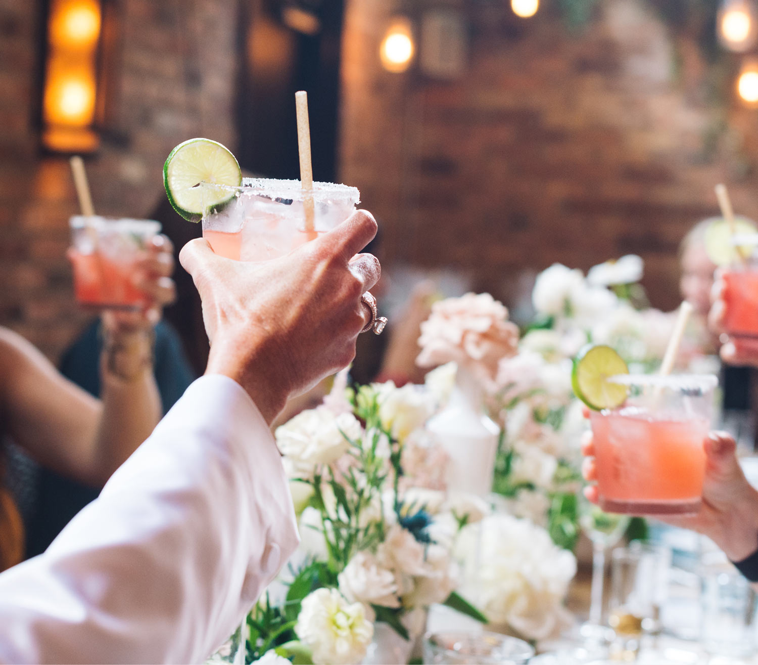 People holding up cocktails made with Inspiro Tequila