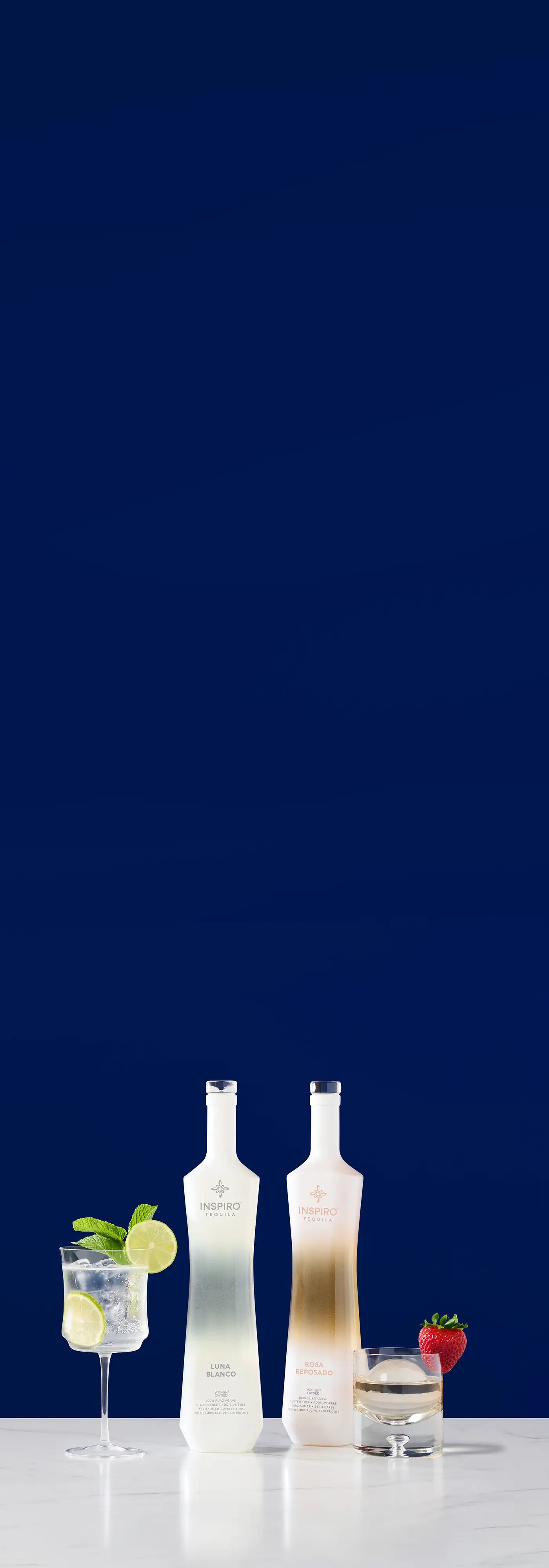 Two bottles of Inspiro Tequila with cocktails on a dark blue background